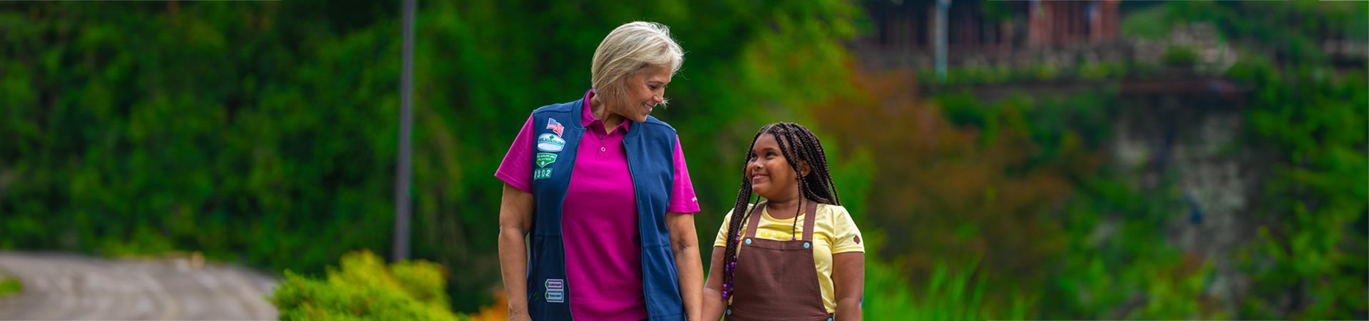  a volunteer walking through a park with a brownie 