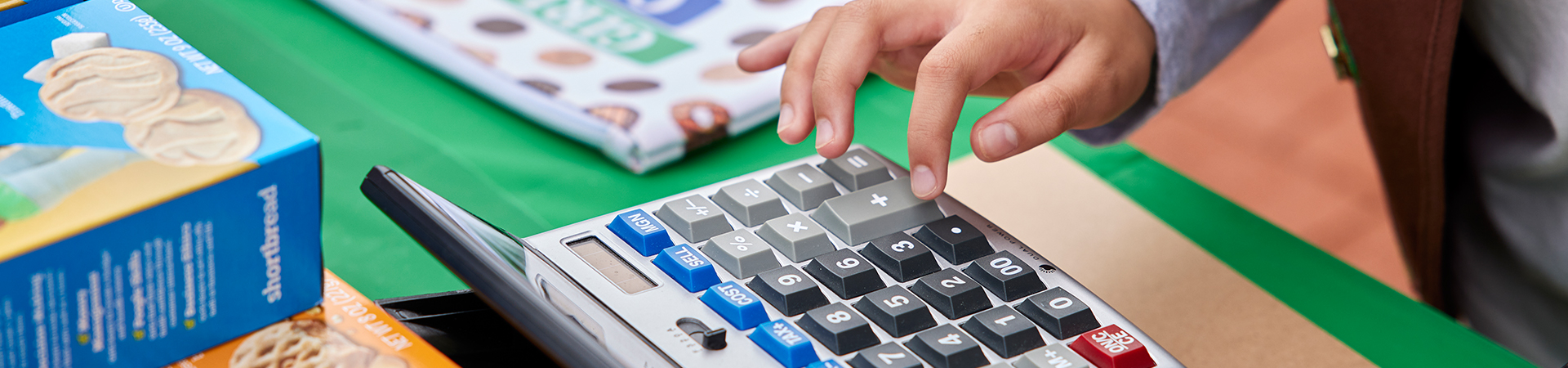  girl using calculator for entrepreneurship and financial literacy activities for kids 