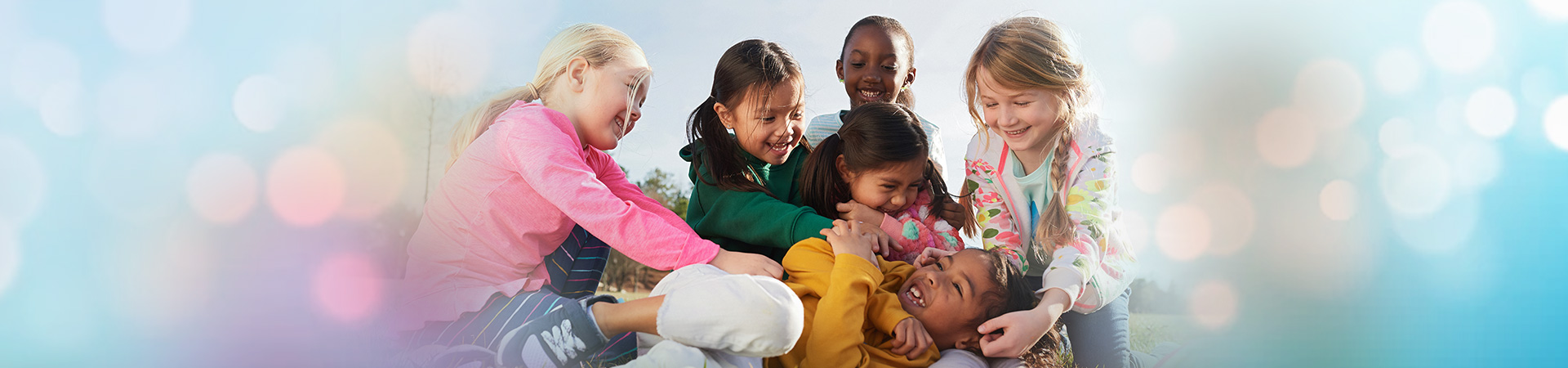  five daisy girl scouts tickling a sixth girl 
