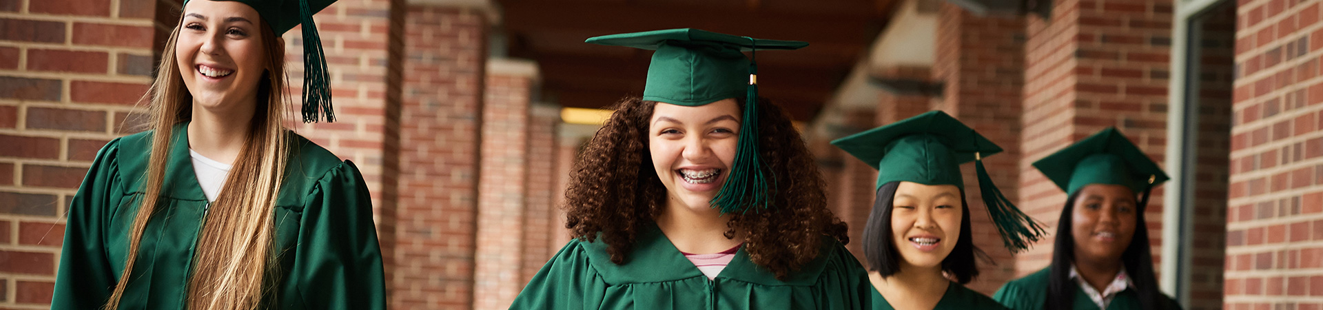  four girls in graduation regalia 