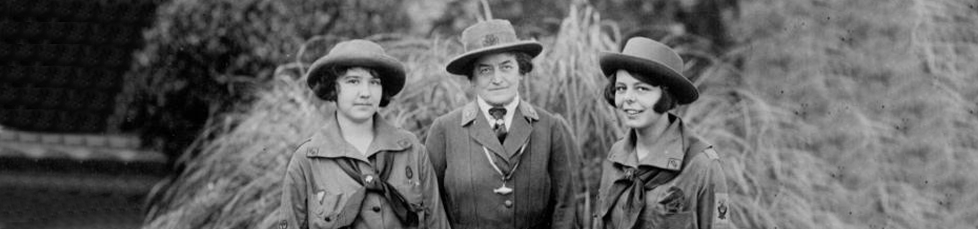  Black and white photo of Juliette Gordon Low "Daisy" with two young girls in vintage Girl Scout uniforms in Savannah Georgia. 